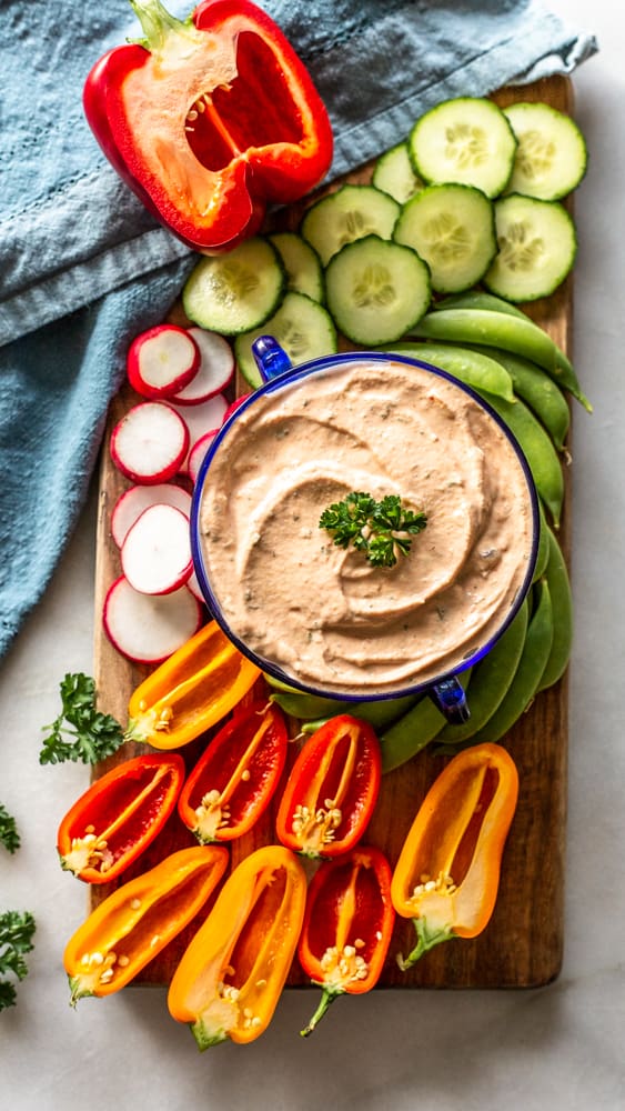 keto thousand island dressing in a bowl surrounded by a variety of vegetables