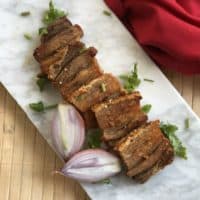 This crispy pork belly is oven baked and then pan seared in ghee to make a delicious protein to go with salad or dipped in your favorite sauce. #whole30 #paleo #keto #lowcarb