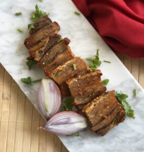 This crispy pork belly is oven baked and then pan seared in ghee to make a delicious protein to go with salad or dipped in your favorite sauce. #whole30 #paleo #keto #lowcarb