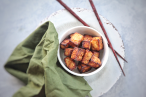 You can made tofu in your air fryer! This recipe for sesame ginger tofu uses a quick marinade with sesame oil, and soy sauce as its base to create a perfect crispy tofu to add to noodle bowls, salads or wraps.
