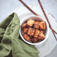 This sesame ginger tofu crisps up perfectly using the air fryer and is ready for salads, noodle bowls, rice and more. #vegan #glutenfree #airfryer #airfryerrecipe