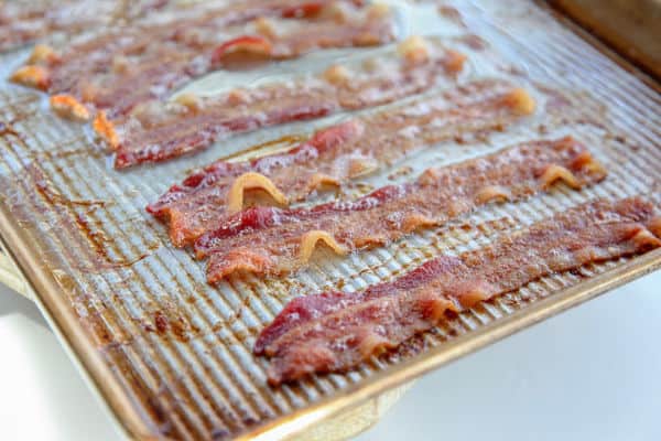 slices of freshly cooked bacon on baking sheet