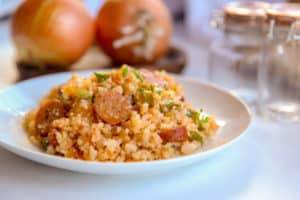 This cajun cauliflower rice is a paleo, whole30, and keto take on dirty rice. It uses riced cauliflower, andouille sausage, pepper, onion and creole and cajun seasonings to make an easy one pot skillet meal. #whole30 #paleo #keto