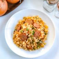 This cajun cauliflower rice is a paleo, whole30, and keto take on dirty rice. It uses riced cauliflower, andouille sausage, pepper, onion and creole and cajun seasonings to make an easy one pot skillet meal. #whole30 #paleo #keto