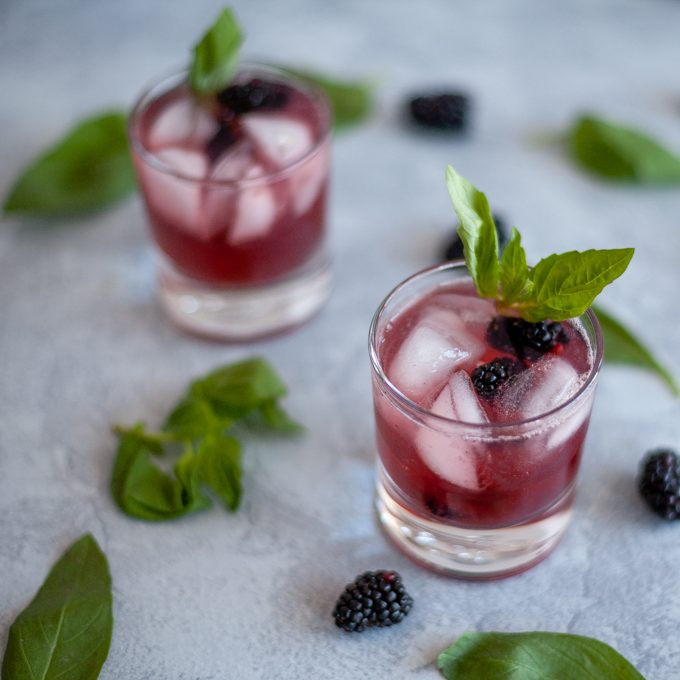 This blackberry basil mocktail may be lacking alcohol but it does not lack flavor! The combination of blackberry, basil and lime sparkling water make a tart and sweet drink great for any party or to have at home without the hangover.