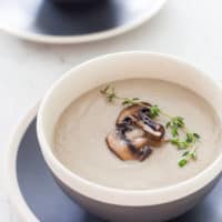 Vegan Cream Of Mushroom Soup in a black and white bowl