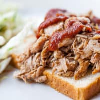 Sous Vide Pulled Pork on an open sandwich, topped with BBQ sauce
