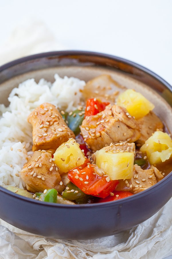 Healthy Sweet and Sour Chicken on rice in a blue bowl