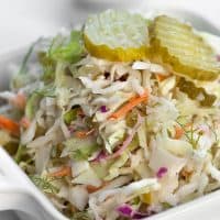 dill pickle coleslaw in a white dish