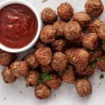air fryer frozen meatballs and marinara sauce in a white dish