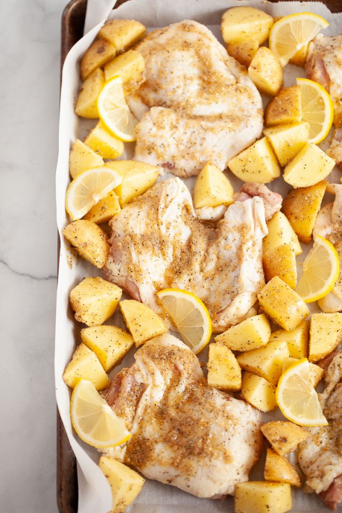 raw chicken thighs with lemon and potatoes