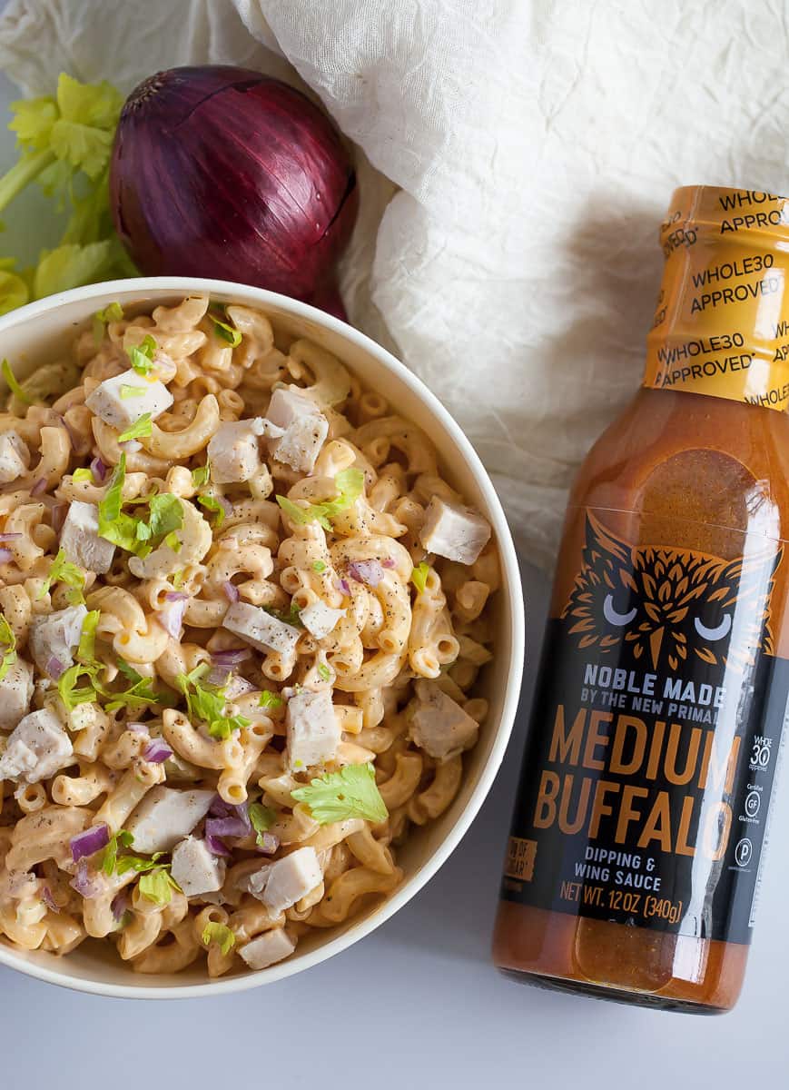 buffalo pasta salad with a jar of buffalo sauce