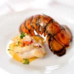 cooked lobster tail on a plate with the shell