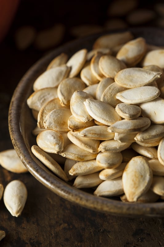 cooked pumpkin seeds in a metal bowl