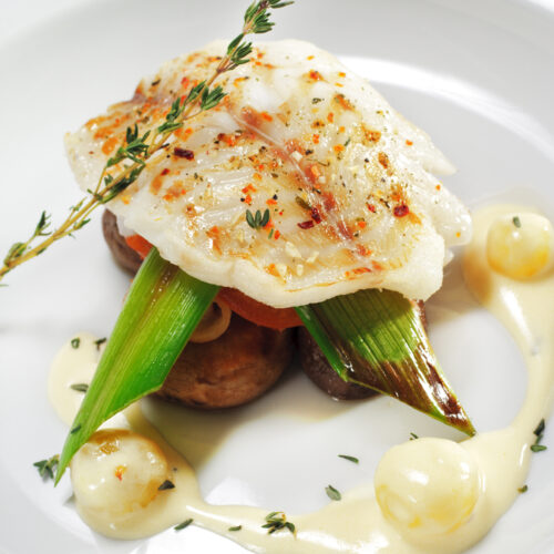 halibut on a plate with vegetables