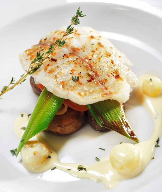 halibut on a plate with vegetables