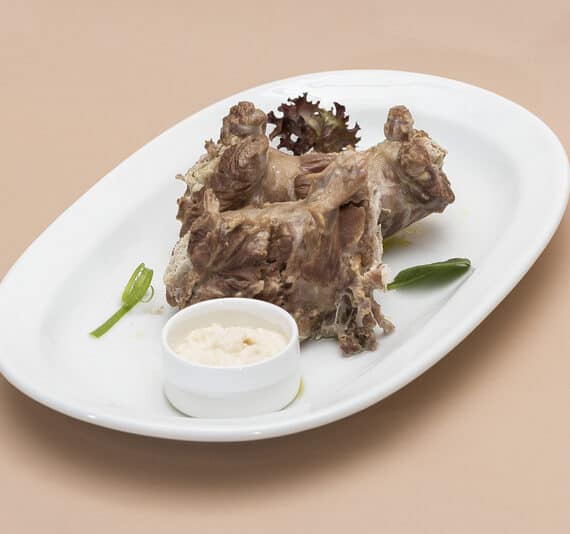 Instant Pot Turkey Necks on a white plate with dipping sauce