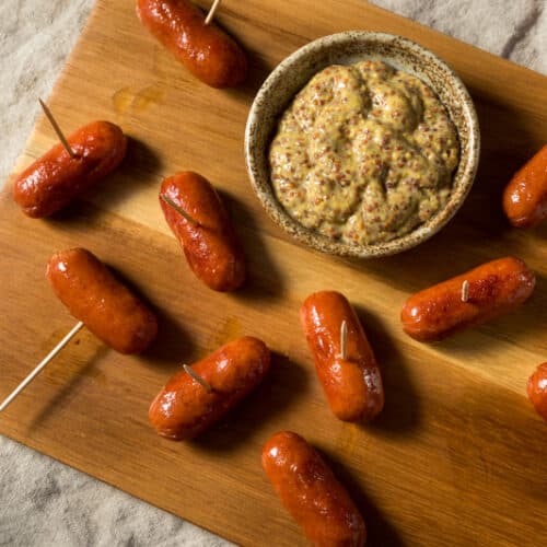 cocktail franks on a platter with mustard