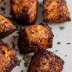 blackened salmon bites on a white plate
