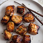 bite sized pieces of cooked salmon with honey garlic marinade
