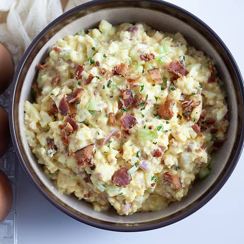 egg salad with bacon on top in a bowl