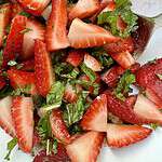 strawberies, mint, lime juice, and sugar mixed together for a summer strawberry salad