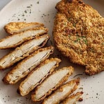 crispy cracker chicken sliced on a plate