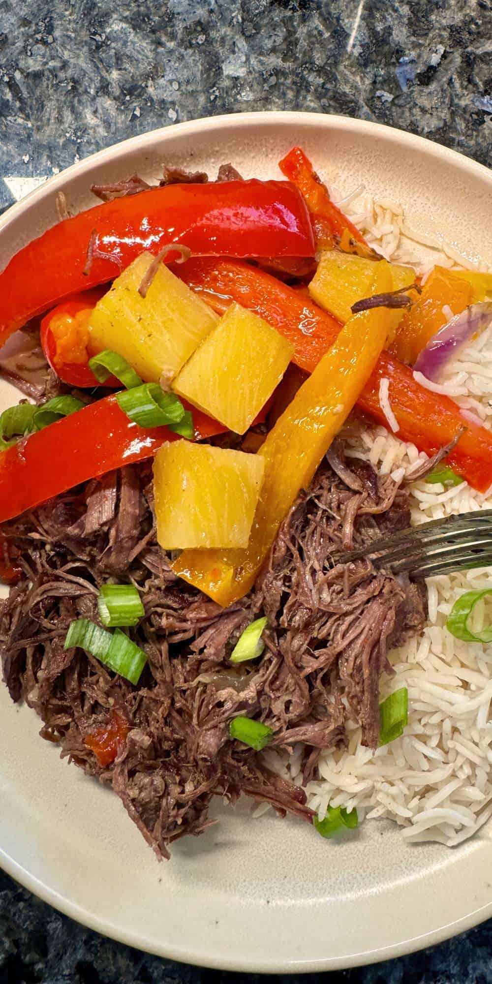 shredded pot roast with peppers, pineapple, and rice cooked in a crock pot