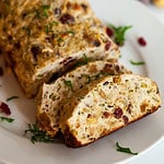 chicken meatloaf sliced on a plate with cranberries and stuffing