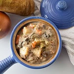 potato and hamburger soup in a blue crock