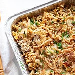 a casserole tray of pasta bake with ground beef, onions, and a creamy sauce