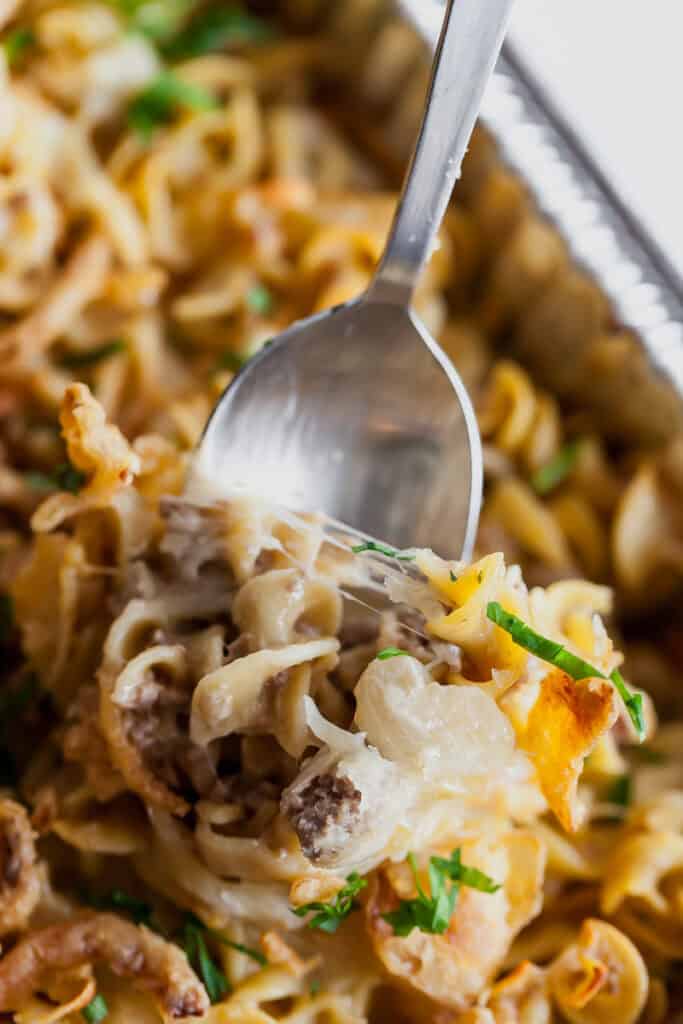 french onion ground beef pasta bake on a spoon