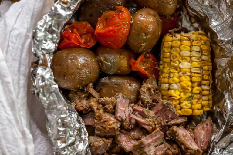 shredded beef, corn, tomatoes, and potatoes cooked in a foil packet