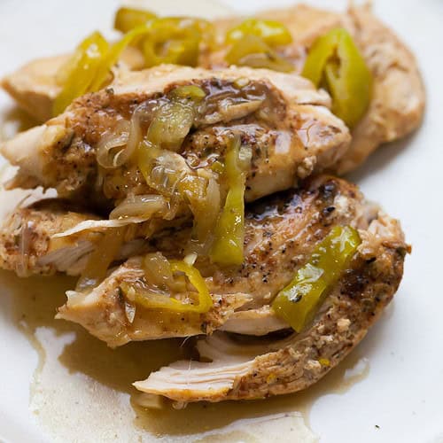 shredded chicken breast with peppers and onions on top