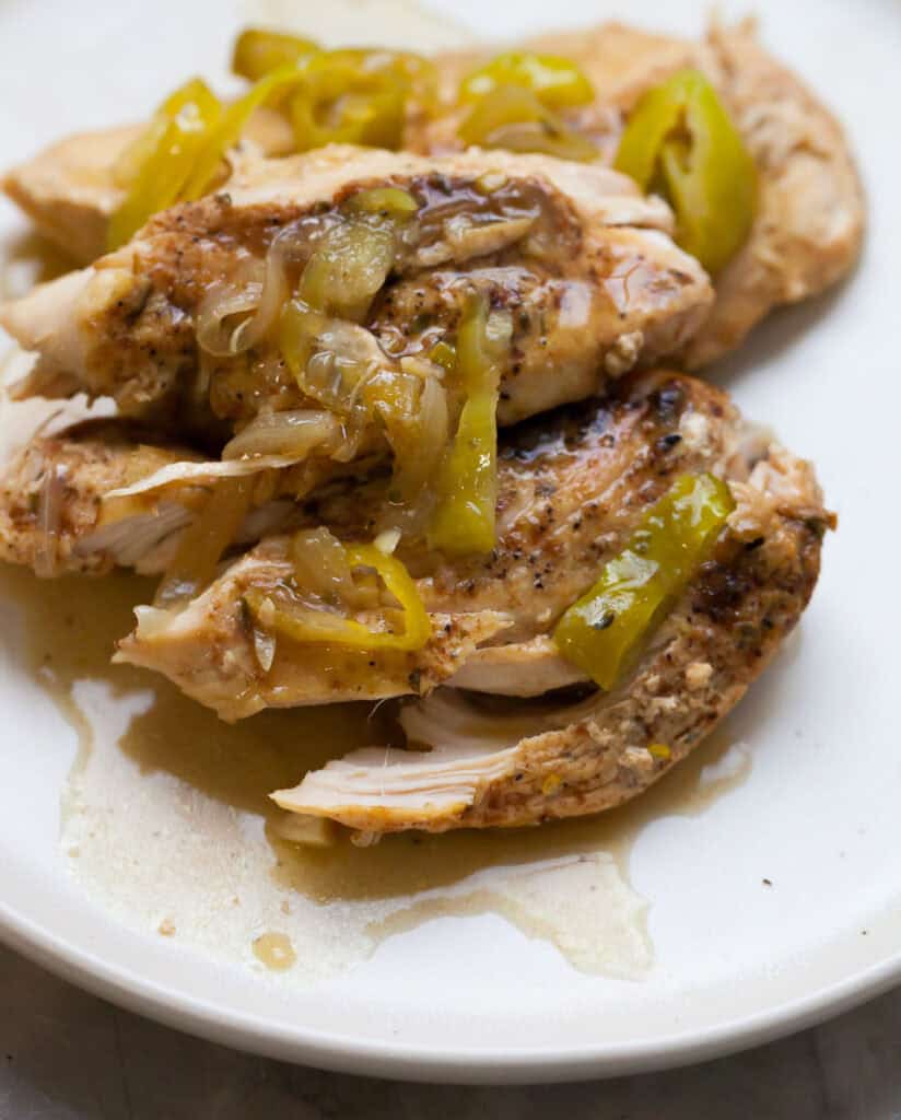 shredded chicken breast with peppers and onions on top