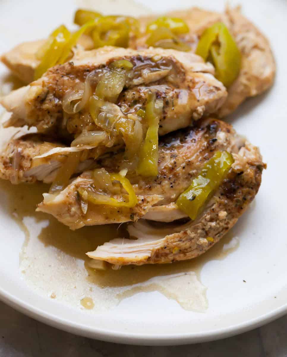 shredded chicken breast with peppers and onions on top